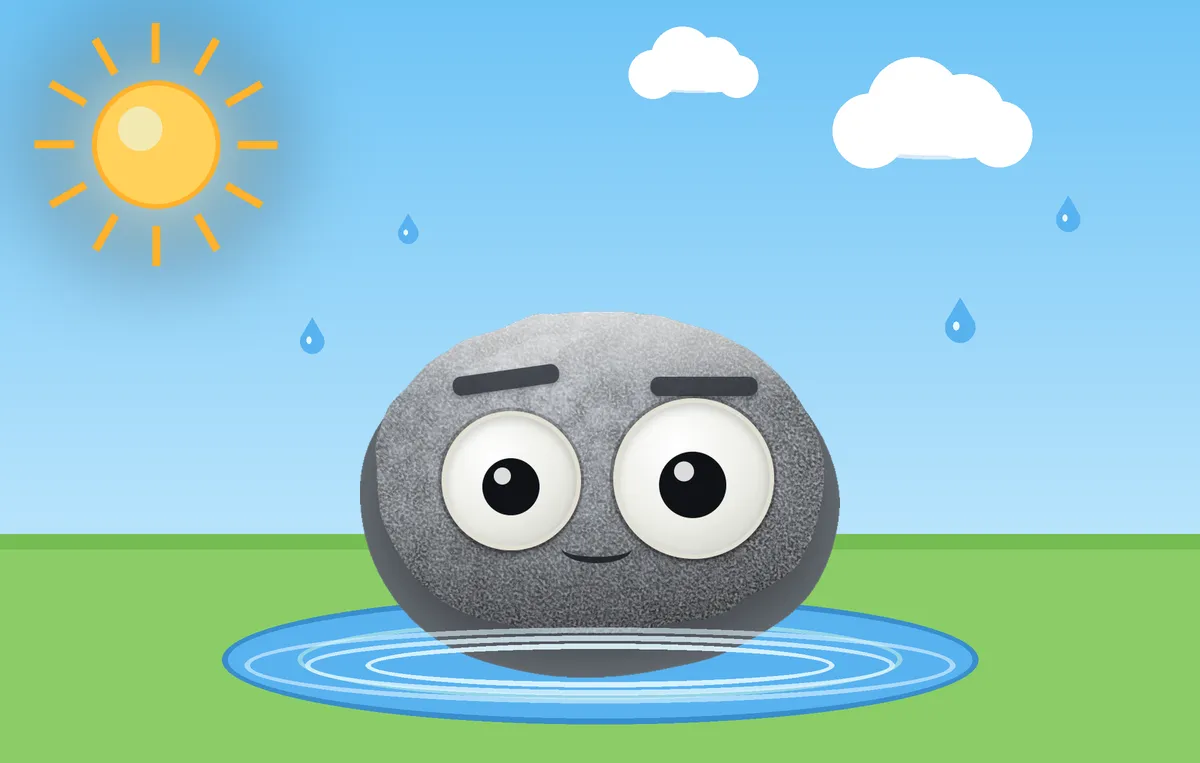 The weather rock sitting in a big blue puddle on a sunny day, with rings spreading around it and a few raindrops still falling.